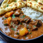 Slow-Cooked Beef Curry in Coconut Gravy with Toasted Garlic Naan